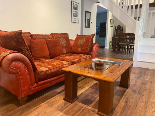 a leather couch and a coffee table in a living room at The Cottage, Walworth Demesne in Ballykelly