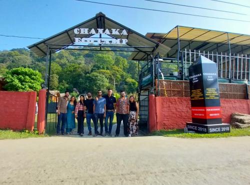 a group of people standing in front of a gate at Chanaka Eco Camp ( Adventure Assam ) in Pakariāmukh