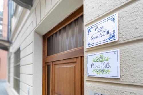 a door to a building with signs on it at Casa SecondoTelli in Turin