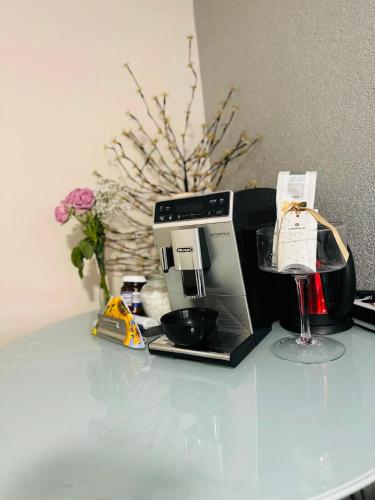 a coffee maker and a wine glass on a table at Carla Maria S Hause in Gammertingen