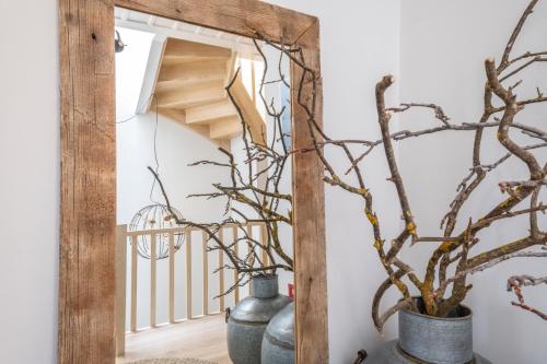 a mirror in a hallway with two vases and a plant at Amymone Suites in Nafplio