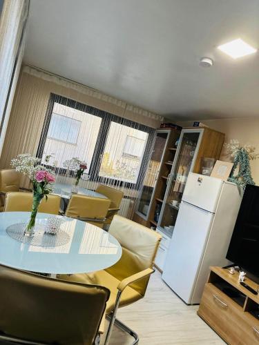 a dining room with a table and a refrigerator at Carla Maria S Hause in Gammertingen