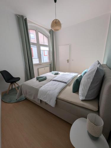 a bedroom with a bed and a chair and a window at Appartement Napoleon in Meißen