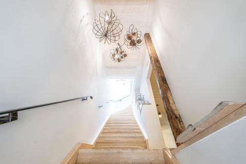 a staircase in a house with a chandelier at Amymone Suites in Nafplio