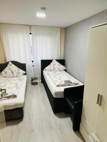 a small room with two beds in it at Carla Maria S Hause in Gammertingen