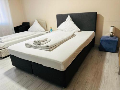 a bed with towels on top of it in a room at Carla Maria S Hause in Gammertingen