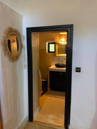 a door leading into a kitchen with a sink at Maison ALPHEA SPA HAMMAM in Marrakech