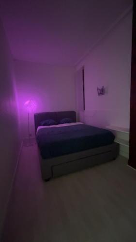 - une chambre avec un lit dans une chambre violette dans l'établissement Appartement Cosy quartier Champs Élysées, à Paris