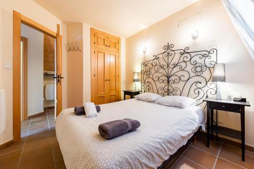 a bedroom with a bed with two pillows on it at Apartamentos Boabdil in Sierra Nevada