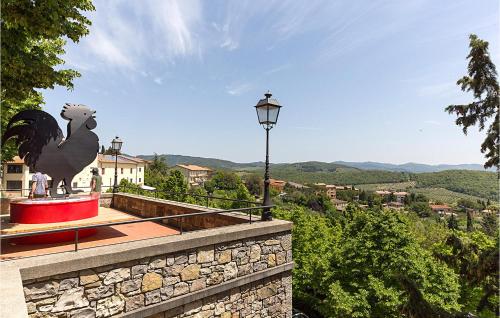 a statue of a bird sitting on top of a building at Beautiful Home In Rapolano Terme Si in Rigomagno
