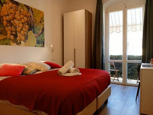 a bedroom with a red bed and a window at Al molo 21 in La Spezia