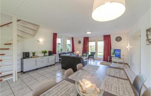 a dining room and living room with a table and chairs at Oesterbaai 8E2 in Wemeldinge