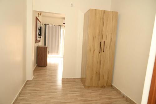 a hallway with a wooden cabinet in a room at shangrila stay in Bodh Gaya