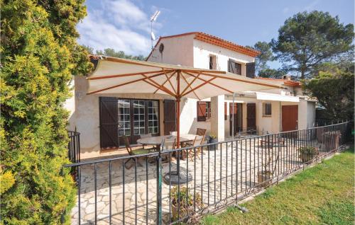 a patio with an umbrella in front of a house at 4 Bedroom Beautiful Home In Mougins in Mougins