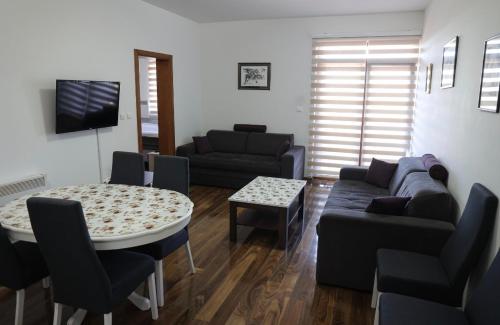 a living room with a couch and a table at Apartman Petar in Nova Varoš