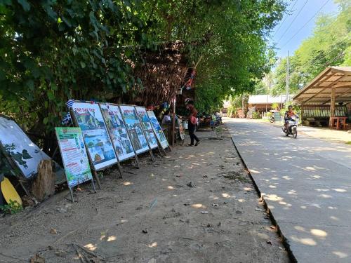 a street with signs on the side of the road at Leam Sai Bungalows Koh Yao Noi in Ko Yao Noi