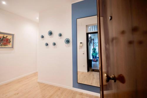 a hallway with a mirror in a room at Politeama Charming Apartment in Palermo