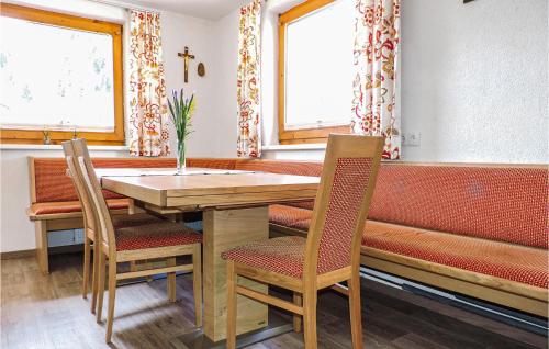 a dining room with a table and two chairs at Ferienhaus In Ruhiger Lage in Kappl