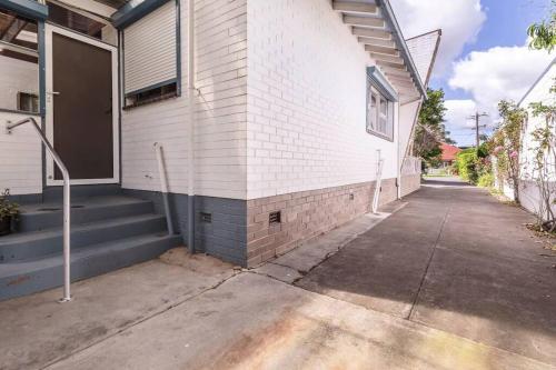a white brick building with stairs on the side of it at Werribee Blast from the Past in Werribee