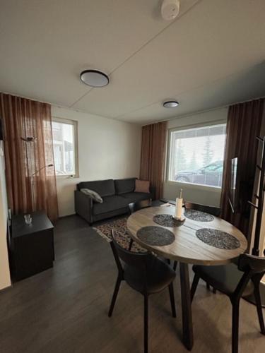 a living room with a table and a couch at Arctic Hill Apartment Ylläs in Ylläs