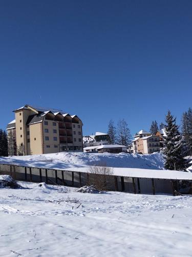 a snow covered city with buildings in the background at Apartman Petar in Nova Varoš