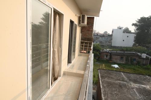 an empty balcony of a house with a window at shangrila stay in Bodh Gaya