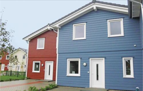 a blue house with a red house at 3 Bedroom Lovely Home In Dagebüll in Dagebüll