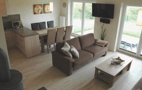 a living room with a couch and a table at Awesome Home In Dagebüll With Sauna in Dagebüll