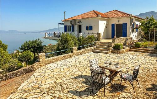 a house with a patio with a table and chairs at Cozy Home In Kitries Kalamata in Kitriaí