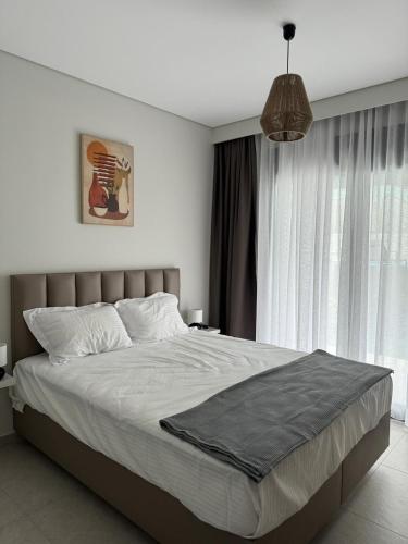 a bedroom with a large bed and a window at Artion Cozy Residence Nikiti in Nikiti