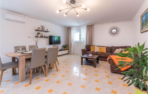 a living room with a table and a couch at Beautiful Apartment In Donje Rastane in Donje Raštane