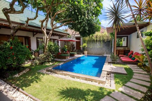 a swimming pool in the yard of a house at Delight ART Villas in Seminyak