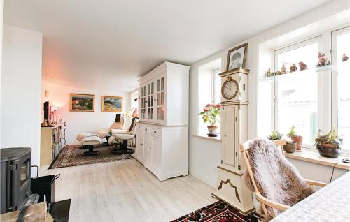 a living room with a clock on a wall at Two-Bedroom Holiday Home In Ronne in Rønne