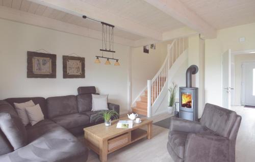 a living room with a couch and a table at 3 Bedroom Cozy Home In Dagebüll in Dagebüll