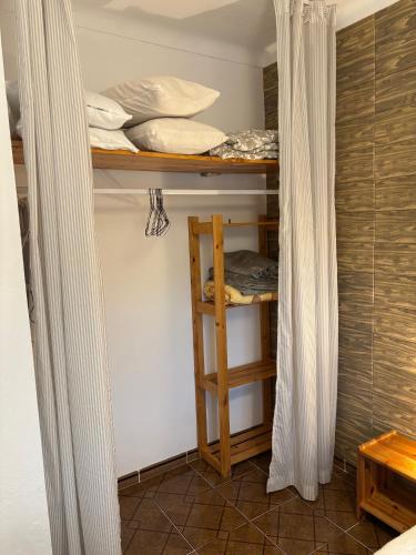 a room with a bunk bed with a wooden shelf at Casa do Henrique in São Luis