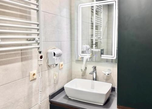 a bathroom with a sink and a mirror at Business class studio with the Mountain View 115А in Batumi