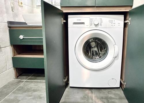 a washer and dryer in a small kitchen at Business class studio with the Mountain View 115А in Batumi