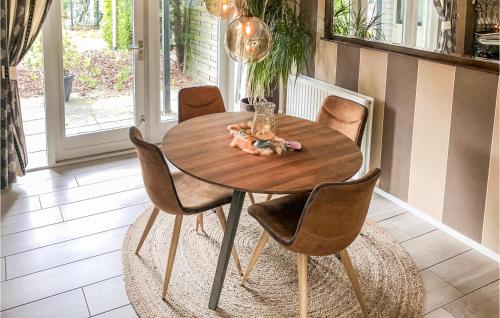 a wooden table and chairs in a room at Residentie De Mors Type Dinkel in Delden