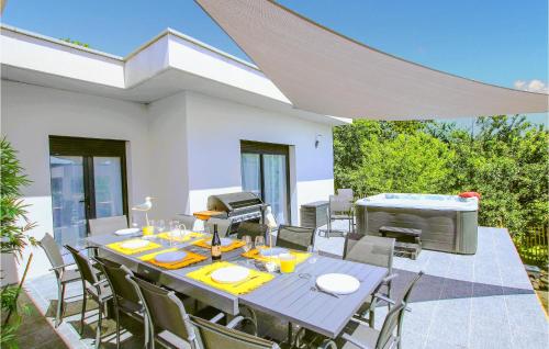 a dining room with a table and chairs on a patio at Beautiful Home In Montélimar in Montélimar