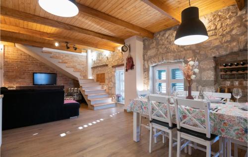 a kitchen and dining room with a table and chairs at Awesome Home In Glavina Donja in Donja Glavina