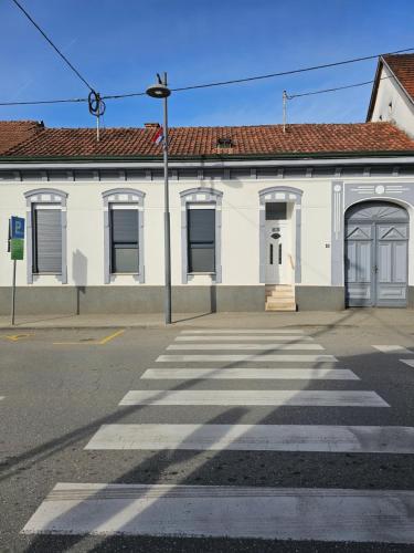 an empty street in front of a white building at Vespera in Požega