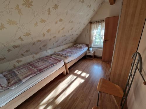 a bedroom with a bed in the corner of a room at Ferienwohnung Landhaus Auf dem Hollo in Petershagen