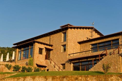 a large brick building with stairs in front of it at Pliadon Gi Mountain Resort & Spa in Kato Trikala Korinthias
