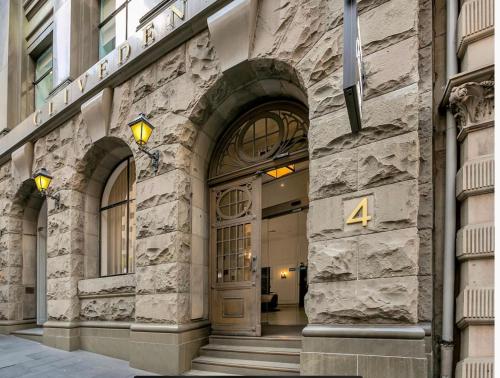 a building with a door with the number four at Cliveden on Bridge in Sydney