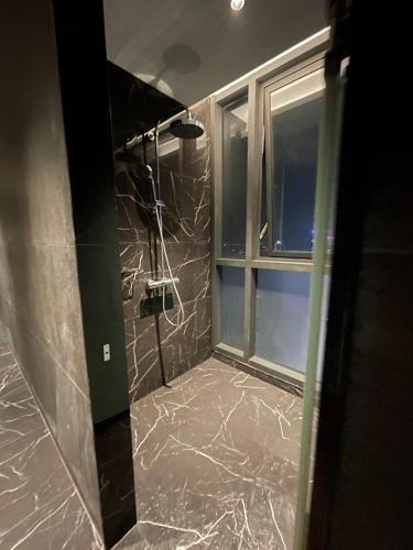 a bathroom with marble floors and a window at Edge Central Pattaya By Su in Pattaya Central