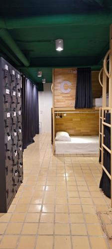 a room with two beds and a green ceiling at Your Place Inn in Karon Beach