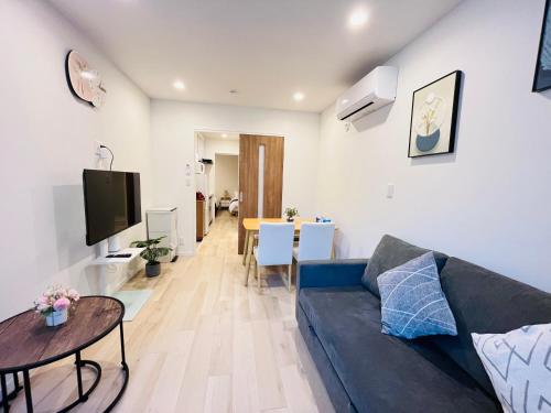 a living room with a couch and a table at Year-end promotion 2 Gread location 1min to Station Closs Ueno Max 6 people Wi-fi unlimited in Tokyo