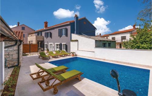 a swimming pool with lounge chairs and a house at Cozy Home In Hreljici in Hreljići