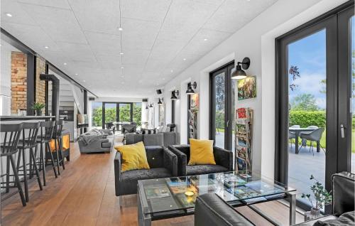 a living room with couches and a table at Gubbegård in Neksø