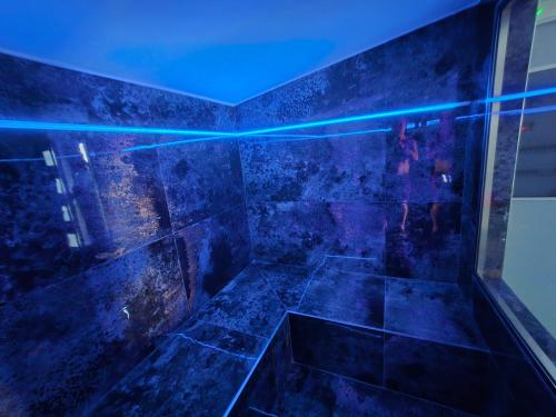 a dark bathroom with a blue light on the tub at Villa Aurelia Privat Pool in Kolimbia